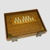 Lower side view of a closed teak shruti box displaying natural wood grain and stable wooden feet