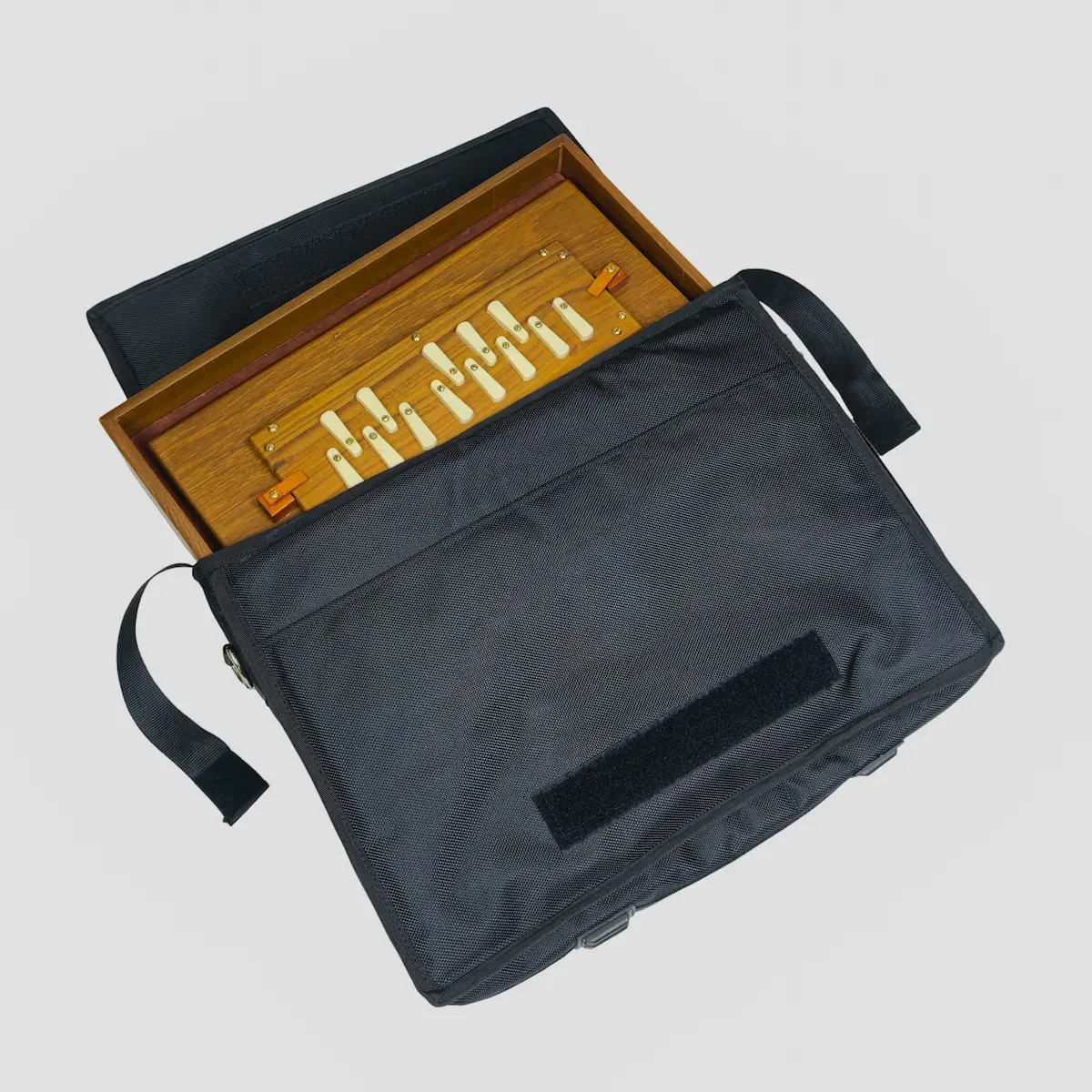 Teak wood shruti box sliding easily into its protective black padded travel case