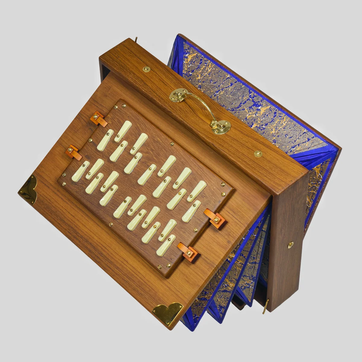 Top-down view of a handmade Indian Shruti Box showing the brass handle and wood finish