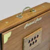 Close-up of the National Music brand engraving and brass carry handle on a Shruti Box